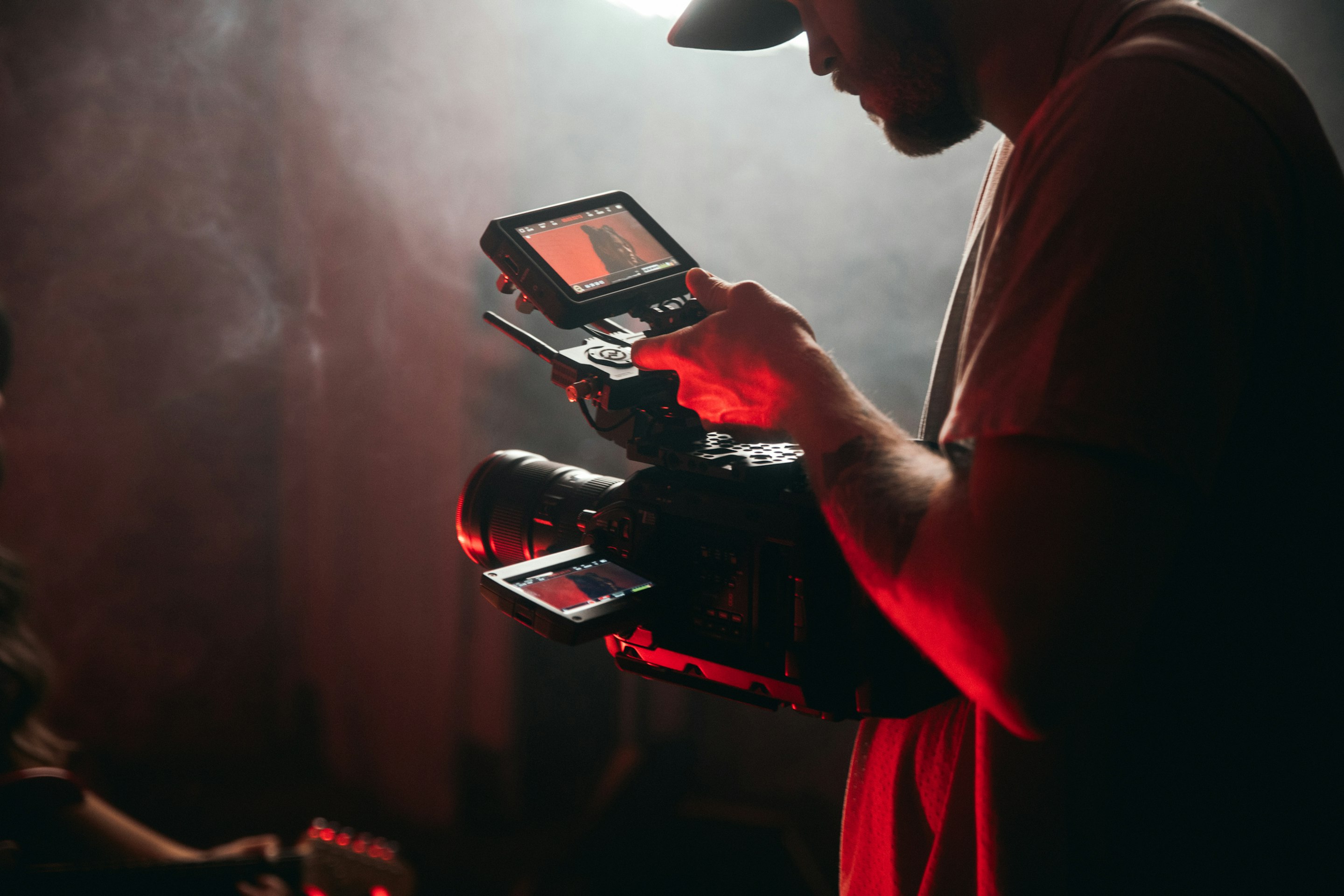A videographer operating a camera during a content shoot